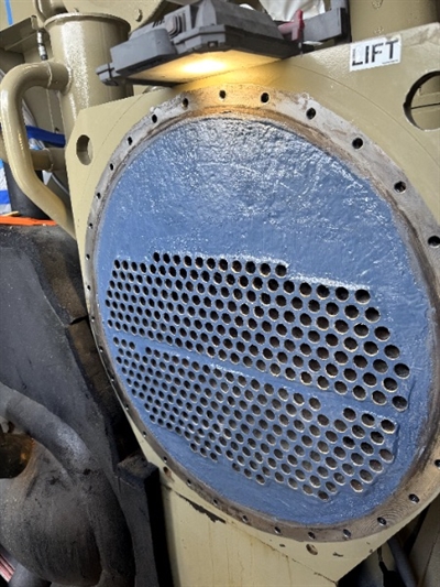 Final view of heat exchanger tube sheet coated with Belzona 1321; all plugs removed, showing clean and restored surface.
