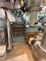 Corroded heat exchanger access cover showing metal loss and deterioration.