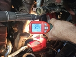Infrared thermometer showing curing temperature on the engine block.