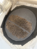 Blasted heat exchanger tube sheet with corks inserted in each tube and a uniform surface profile.