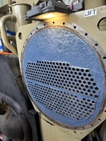 Final view of heat exchanger tube sheet coated with Belzona 1321; all plugs removed, showing clean and restored surface.