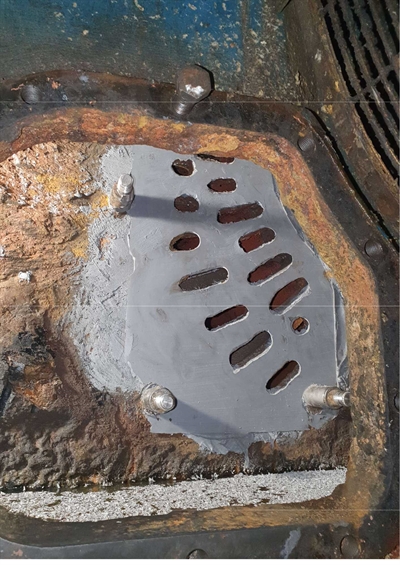 A plate has been bonded over the former corroded areas to keep the product in place