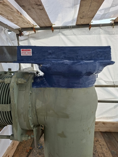 An encapsulating wrap covers the entire affected area, including onto the supporting girder.