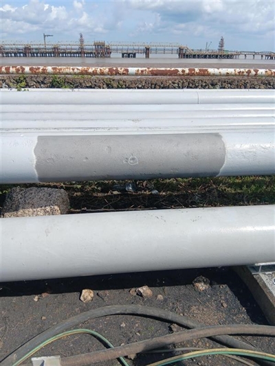 A series of wide external pipes with a pitted one at the front