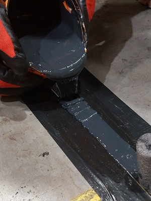 A liquid repair is being poured into the joint