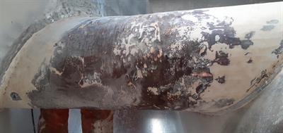 A screw conveyor showing signs of erosion and wear