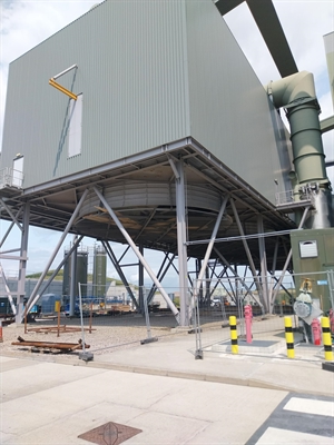 A large corroggated metal container standing off the ground