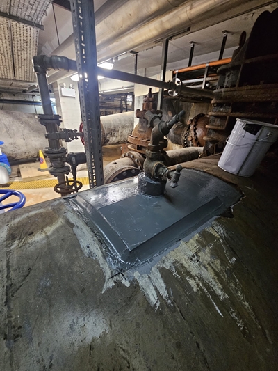 Completed application of plate bonding over old corroded surface, with a smooth edged finish