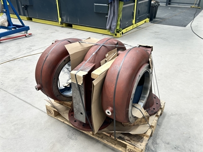 three pumps tied together on a pallet inside a warehouse
