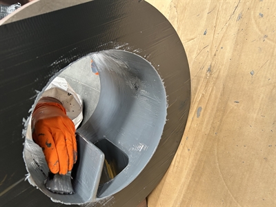 An engineer with a paintbrush is applying the solution