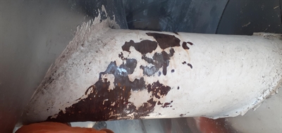 Close up of eroded screw conveyor shaft