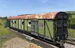 A vintage style train carriage on an abandoned rail line