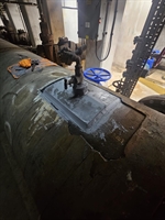 The plate has been bonded around the nozzle with Belzona 1111 on the mixing board next to it