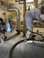 Person vapour blasting the top surface of tank.
